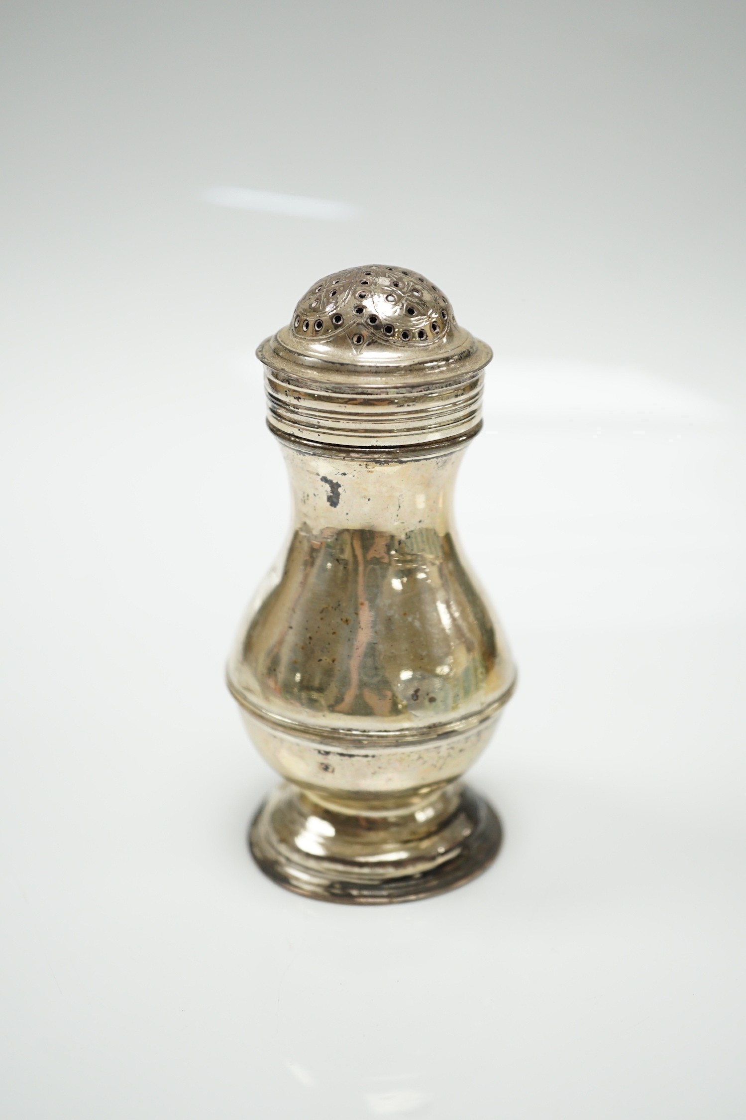 An early George II silver pepperette, maker's mark rubbed, London, 1729, 10cm.